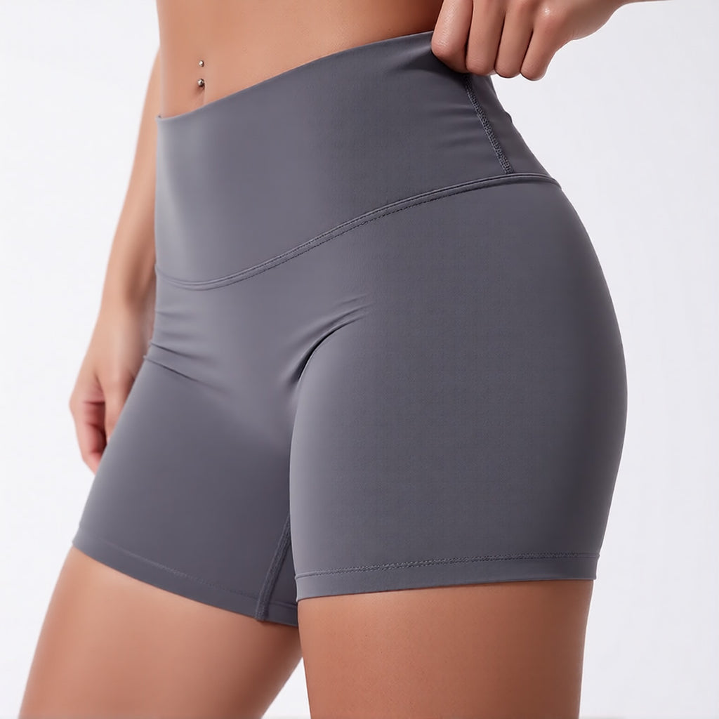 Women's high waisted gym shorts in grey, showcasing the secure wide waistband and athletic performance silhouette | color:grey