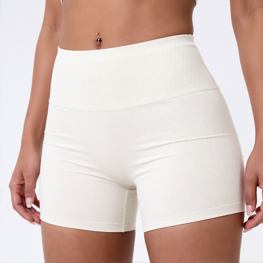 Women's high waisted gym shorts in ivory, showcasing the secure wide waistband and athletic performance silhouette | color:ivory