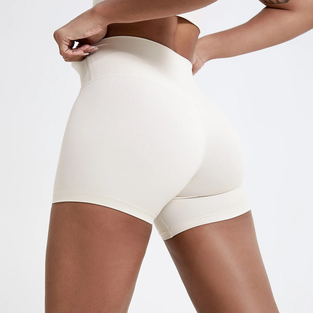 Women's high waisted gym shorts in ivory, rear detail view showcasing the secure wide waistband and seam contruction | color:ivory