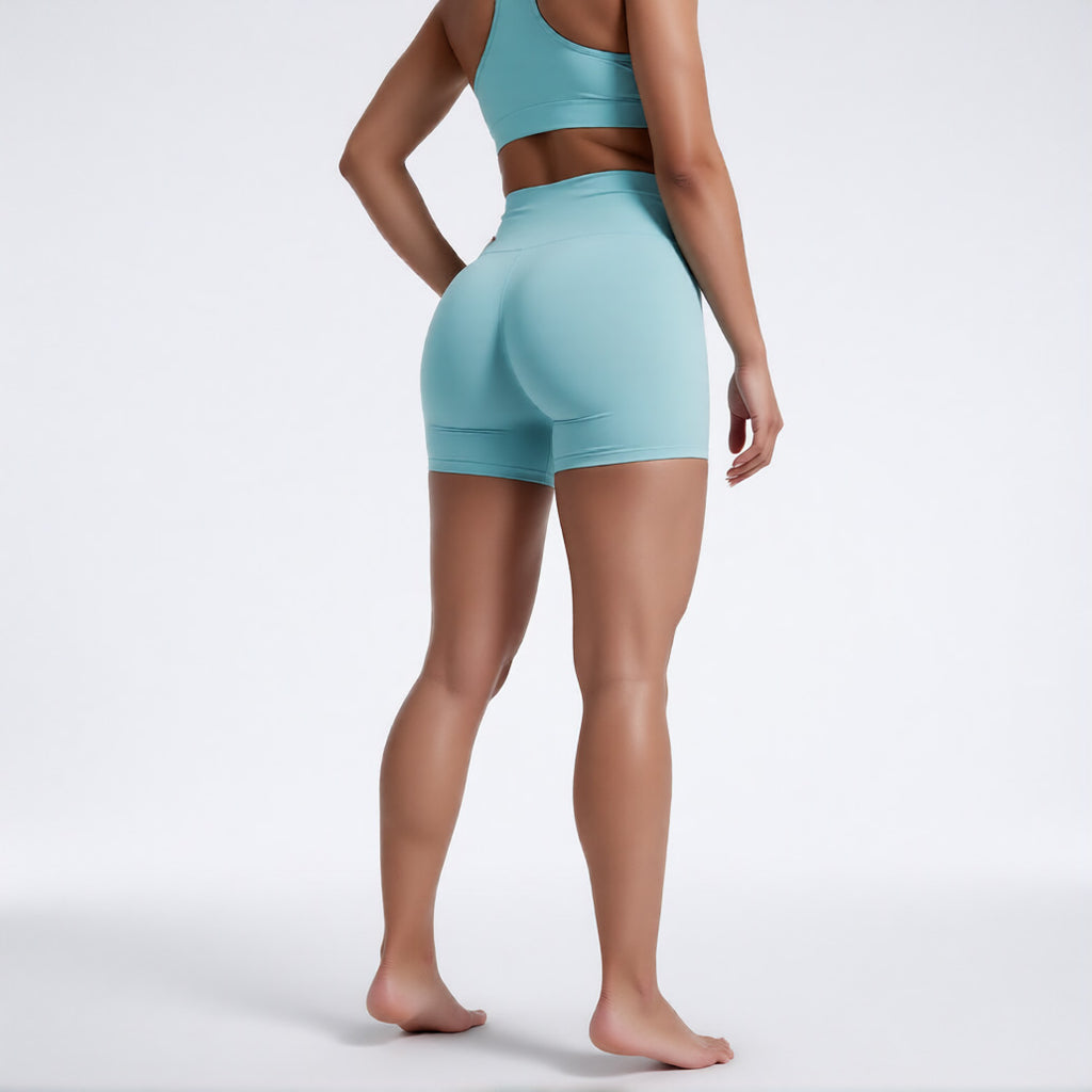 Women's high waisted gym shorts in light blue, rear view showcasing the secure wide waistband and athletic performance silhouette | color:light blue