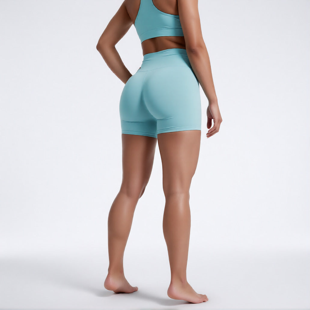 Women's high waisted gym shorts in light blue, rear view showcasing the secure wide waistband and athletic performance silhouette | color:light blue