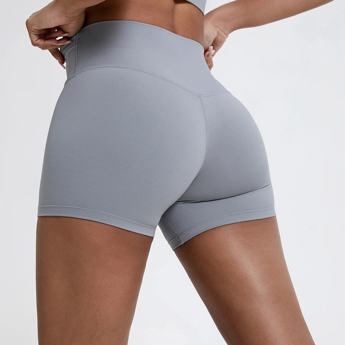 Women's high waisted gym shorts in light grey, rear detail view showcasing the secure wide waistband and seam contruction | color:light grey