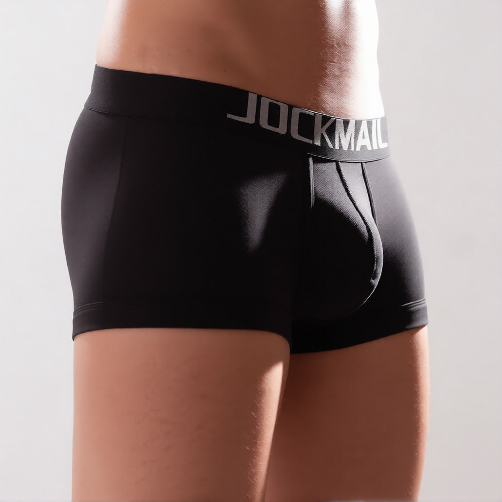 Men's C-ring boxer briefs in black in front three quarter view, showing the enhancing support pouch and comfort waistband | color:black
