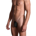 Men's c-string in black on a model, detail side view highlighting the strapless design and zero waistband architecture | color:black