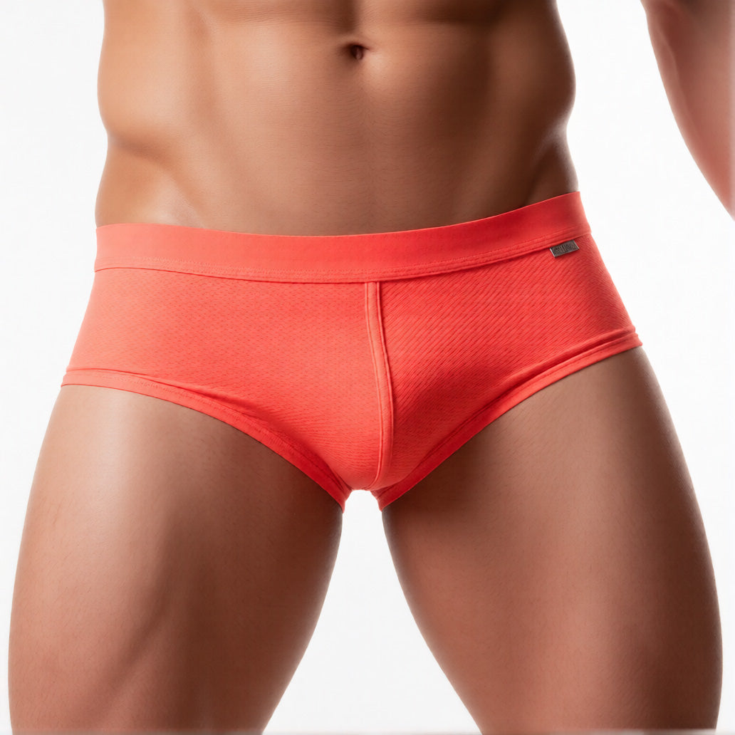 Men’s mesh briefs in orange, highlighting the breathable sheer fabric and low-rise fit | color:orange
