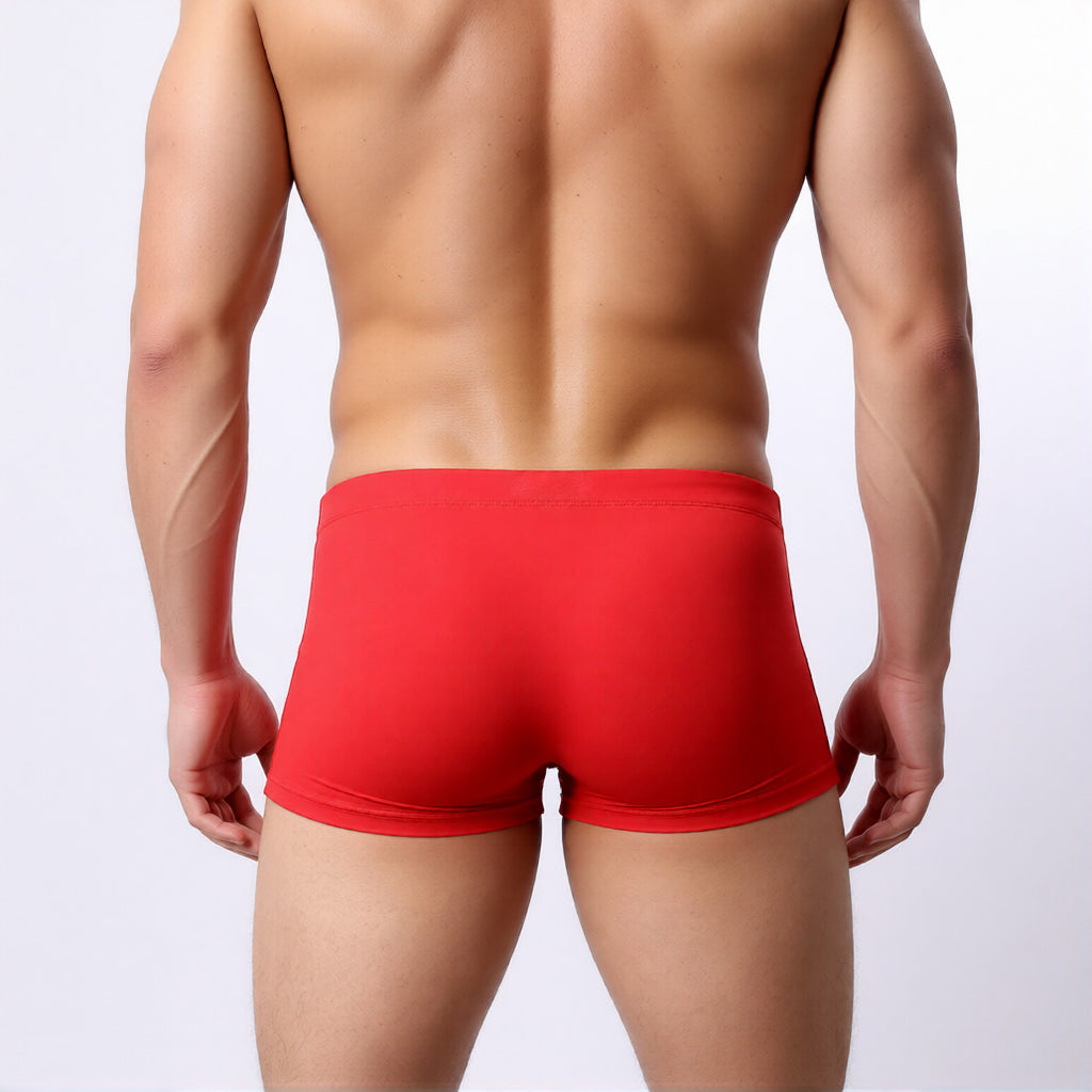 men's swim trunk in red showing the square cut and athletic, low-rise fit from the rear | color:red